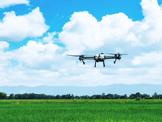 UAV with camera flying over rural area